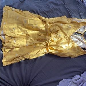 Yellow shirtsleeve romper with small white flowers